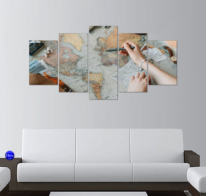 Traveler Tracing a Route on a Vintage World Map With Passport and Tickets