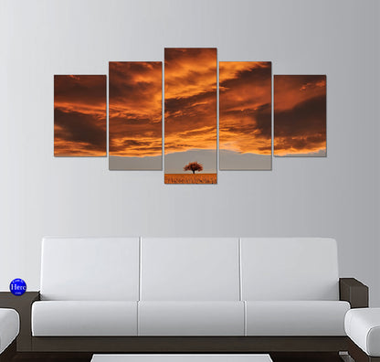 Lone Tree in a Golden Prairie Beneath Fiery Sunset Clouds