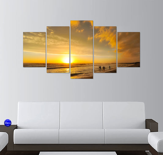 Surfers Walking Along Golden Waves at Sunset